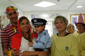 Rozanne Barr with Asi, Sharon and Ori Gorani. Ori, 4, a patient at Hadassah is dressed as a policeman like his Dad Asi  who is a real policeman.