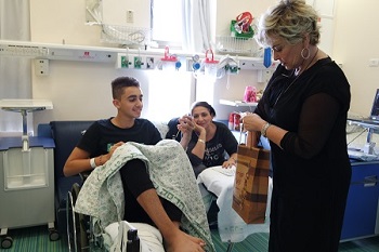 Rozanne Barr with patient Daniel Cohen, 15, from Jerusalem. "My mother is a big fan of Rosanne's and having her come cheered us up on a day when I'm stuck in the hospital missing Purim fun." 
