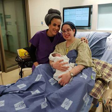 Midwife Noam Gamliel with mom and baby